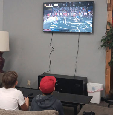 CrossWord Cafe - kids playing a video game and hanging out